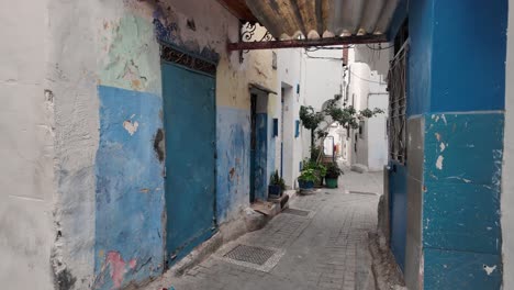 charming blue street scene in tangier's medina showcasing vibrant wall art and quiet alley