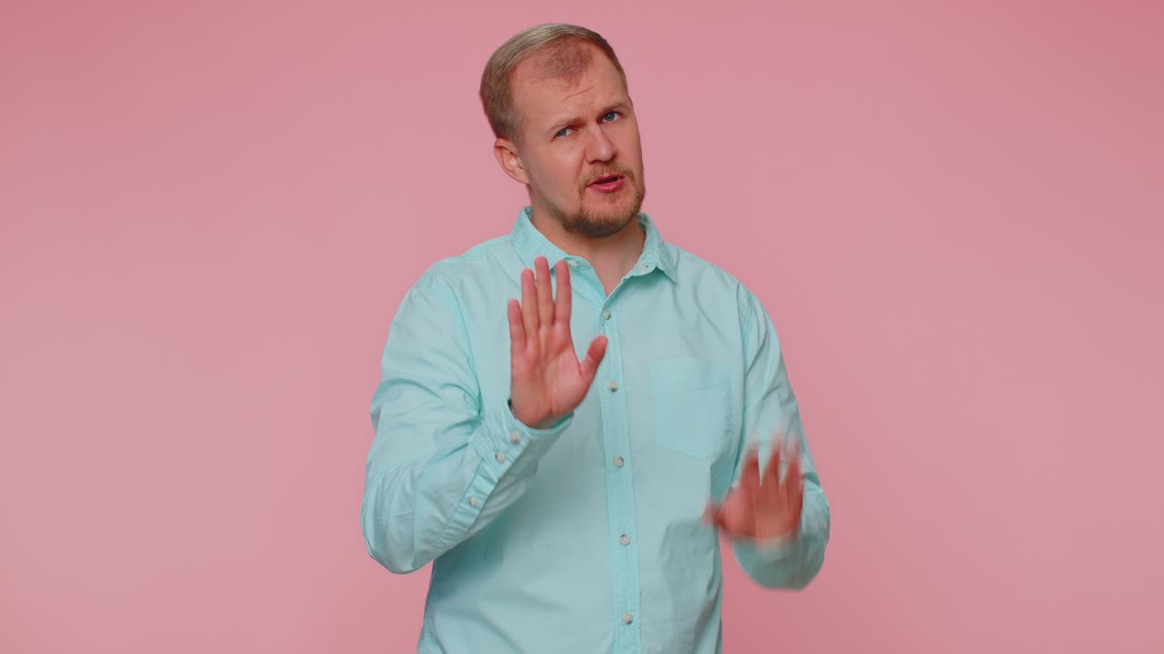 Man warning with admonishing finger gesture saying no be careful avoid danger disapproval sign