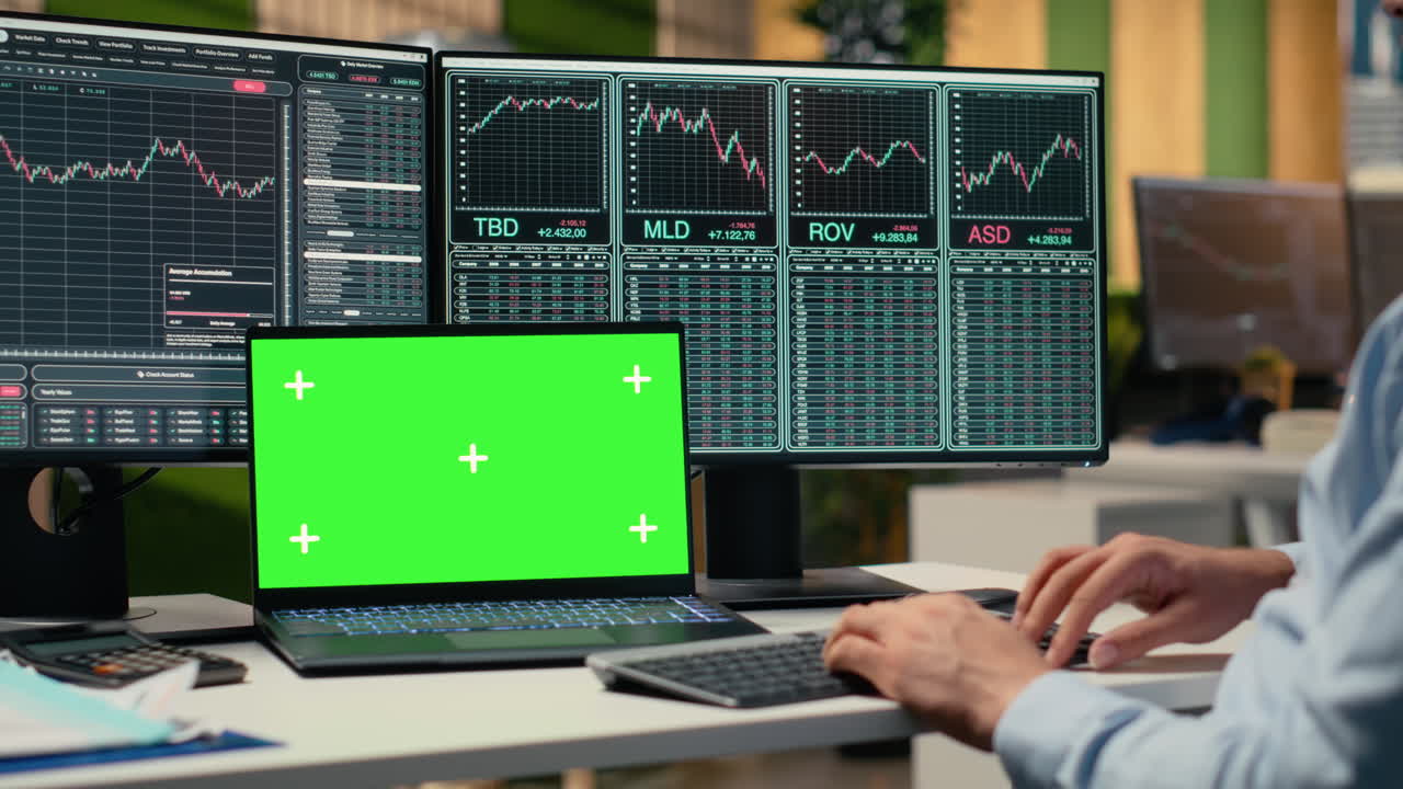 Day trader in office analyzes stock market charts on isolated screen laptop