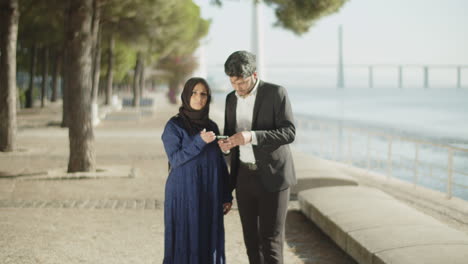 arabic middle east couple using smartphone for destination