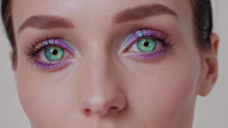 close-up of woman with colorful eye makeup