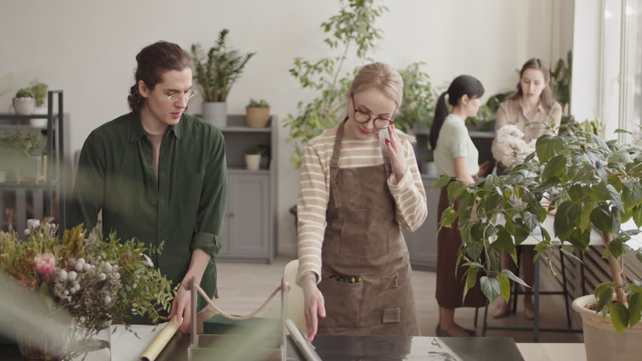 Manager Teaching Employee in Flower Shop