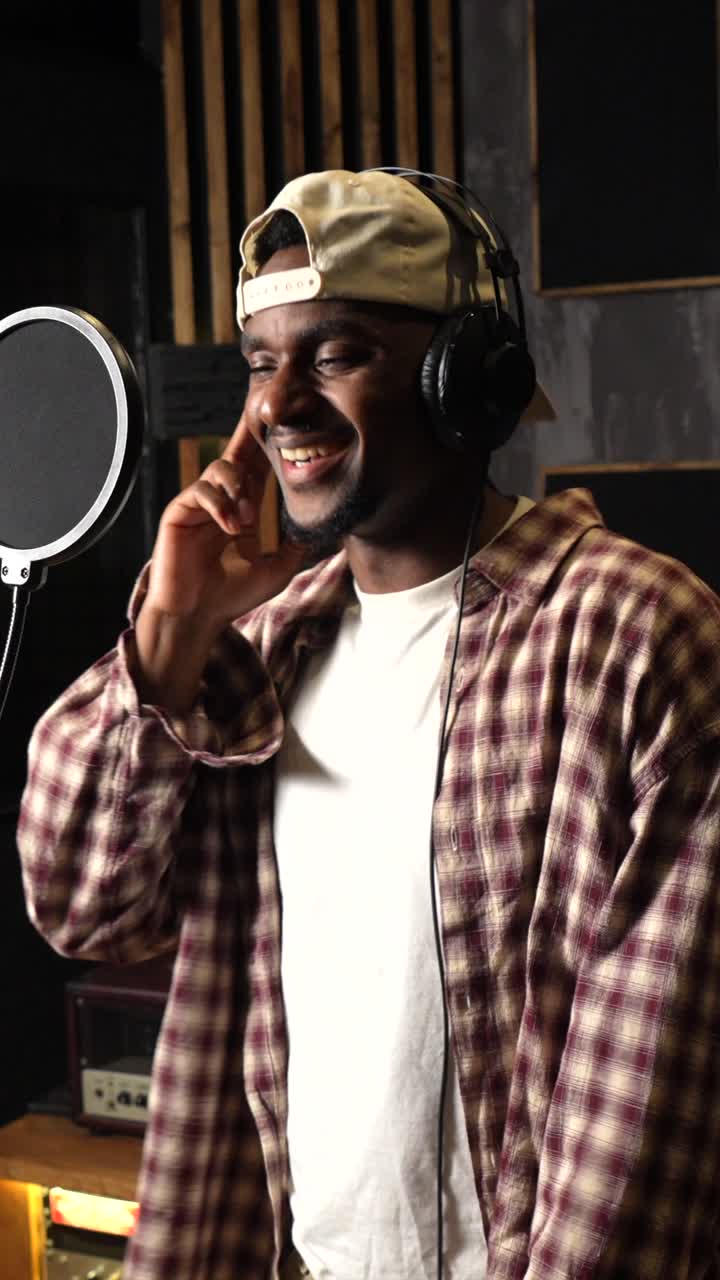 Man singing into a microphone in a recording studio