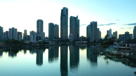 flying over still canal waters to reveal spectacular sunrise, surfers paradise