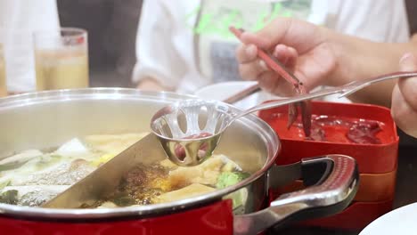 preparing hotpot with pork liver and vegetables