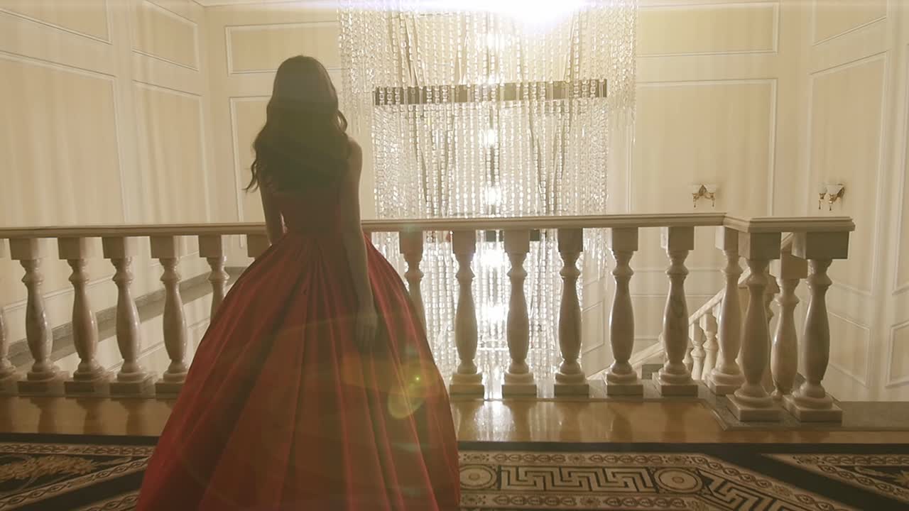 Woman in Red Ball Gown on a Balcony