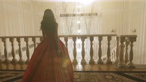 woman in red ball gown on a balcony