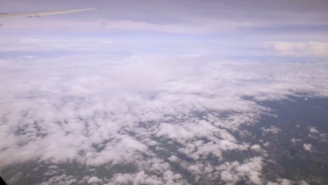 A-view-of-the-upper-plane-window-while-floating-in-the-air,-overlooking-the-mountains-and-natural-water-resources-along-the-coast-of-Thailand