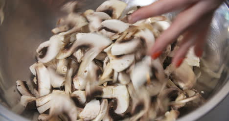 chef slicing mushrooms in kitchen 6