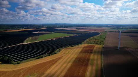 Aerial-view-of-rotating-wind-turbine-on-agricultural