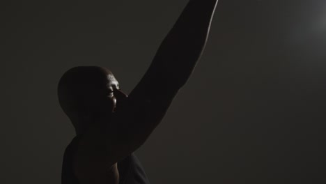 close up side view studio shot of male basketball player shooting ball at basket 5