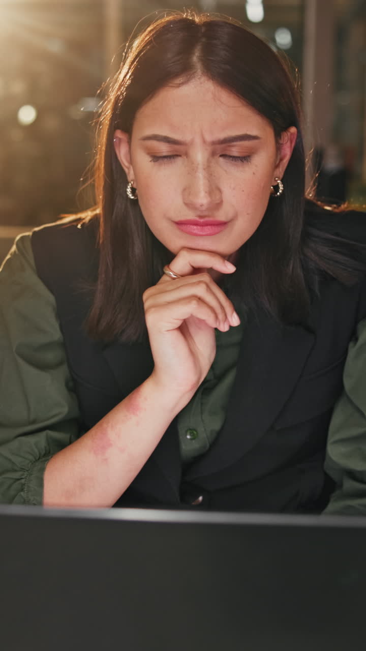 Young Woman Concentrating and Problem Solving on Laptop at Night