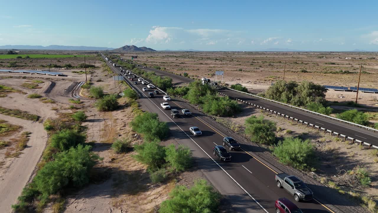 Aerial View of Traffic Jam on Highway in Desert, Cars heading Southbound on Interstate 10 in Arizona, South Mountain in background, bright blue sky, late afternoon in September