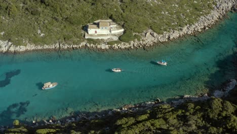 boats on tropical paxos island waters in greece on ionian sea coast