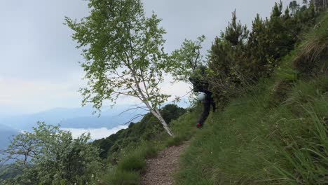 backpacker walking up on trail of grignetta mountain in lecco, lombardy, italy