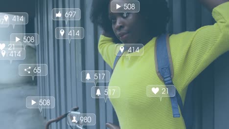 Animation-of-social-media-notifications-over-african-american-woman-standing-in-street-with-bike