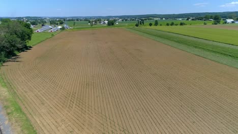 A-Drone-View-of-Recently-Planted-Amish-Farmlands-by-a-Single-Rail-Road-Track-on-a-Summer-Day