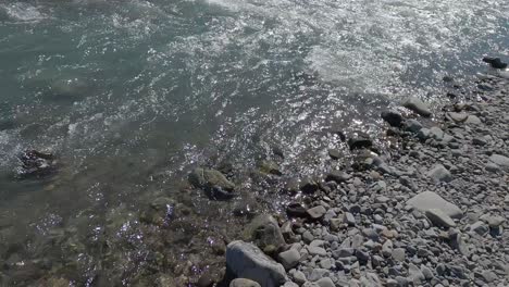 Slow-motion-movement-as-river-narrows-and-drops-slightly-over-rocks-creating-white-water---Kowai-River,-Canterbury