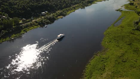 aerial shot of a ferry boat sailing on river nemunas with beautiful nature near kaunas, lithuania-3