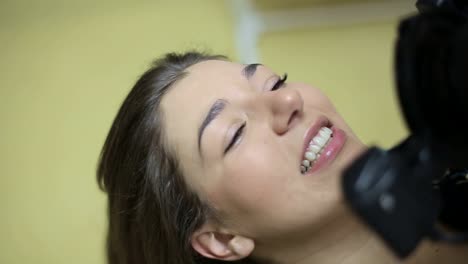 woman smiling during a beauty treatment
