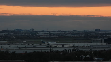 Flashing-strobes-visible-on-aircraft-as-the-sun-sets-over-Pearson-International