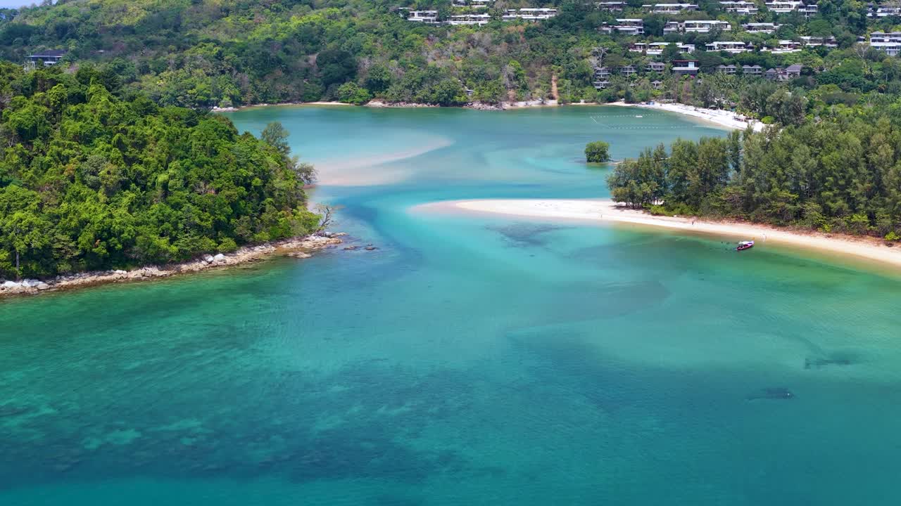 High angle aerial shot of a tropical sandbar and turquoise lagoon under bright sunlight