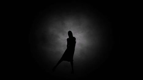 A-modern-youth-dance-performed-by-a-graceful-and-sexy-female-silhouette,-in-the-smoke-against-the-backdrop-of-spotlights