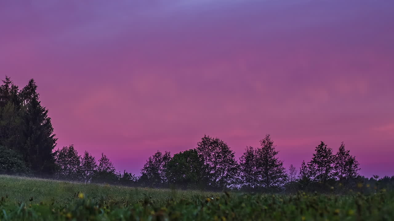 Static view of dark evening after sunset with pink and blue sky in timelapse