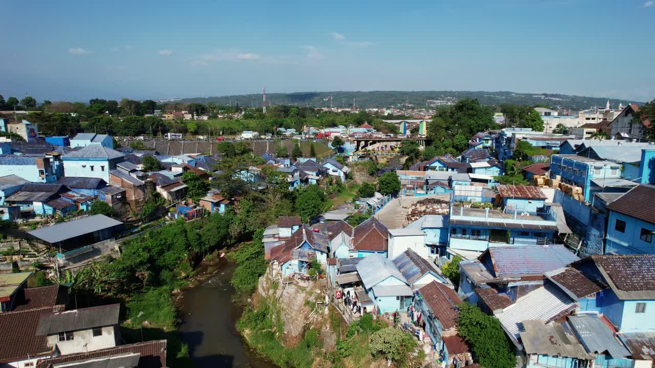 Vibrant blue village painted for local football pride in Malang, aerial view