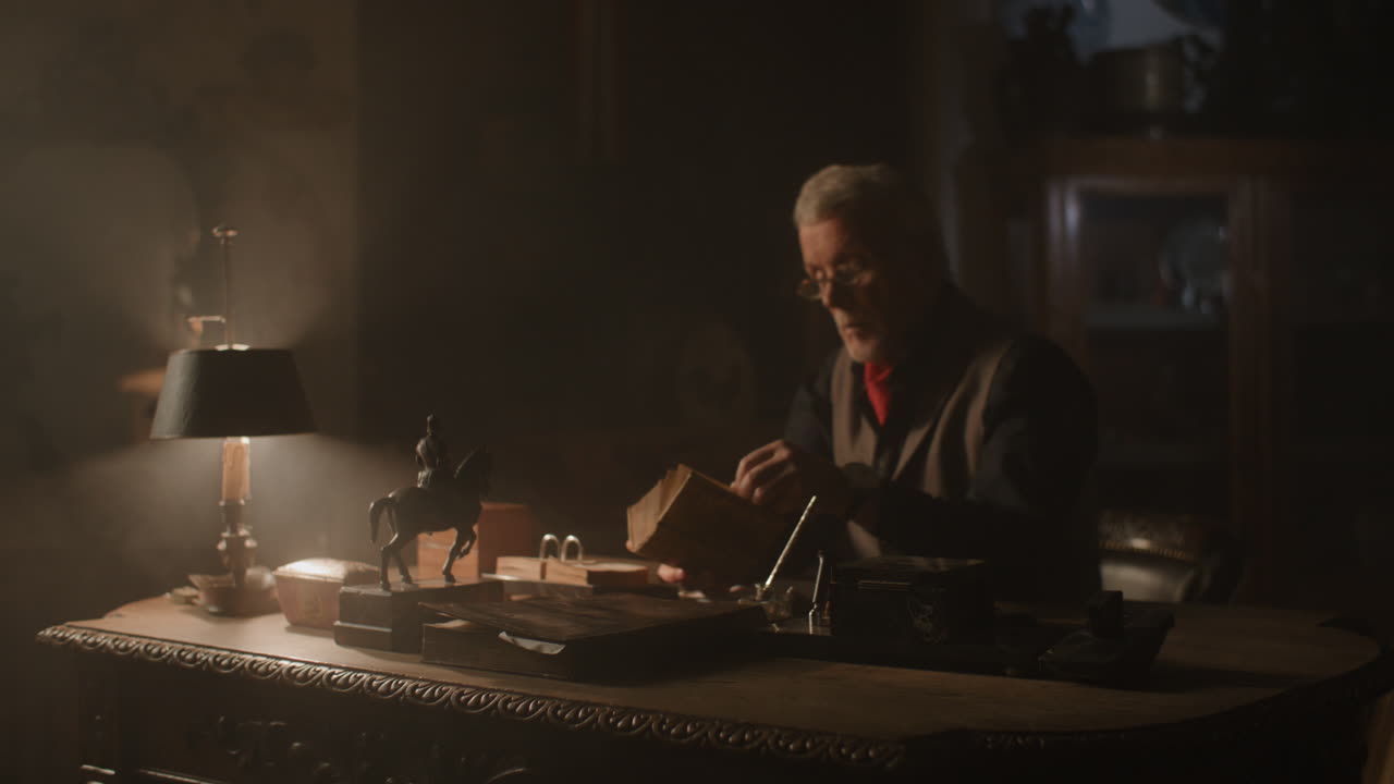 Old passionate man read a book in his office at night