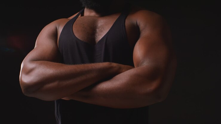 Close Up Of Chest Of Male Athlete Wearing Vest Training Flexing Muscles And Preparing For Sports Event Against Black Studio Background 2