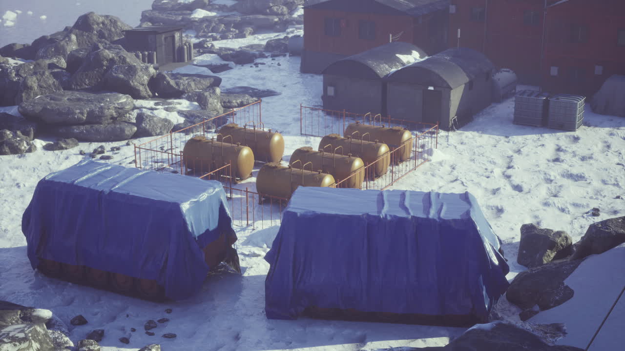 Storage units and tanks located in a snowy environment near a research facility