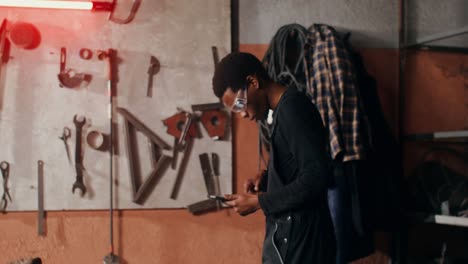 mechanic using a digital tablet in a workshop