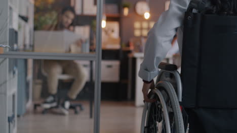 woman in wheelchair in modern office