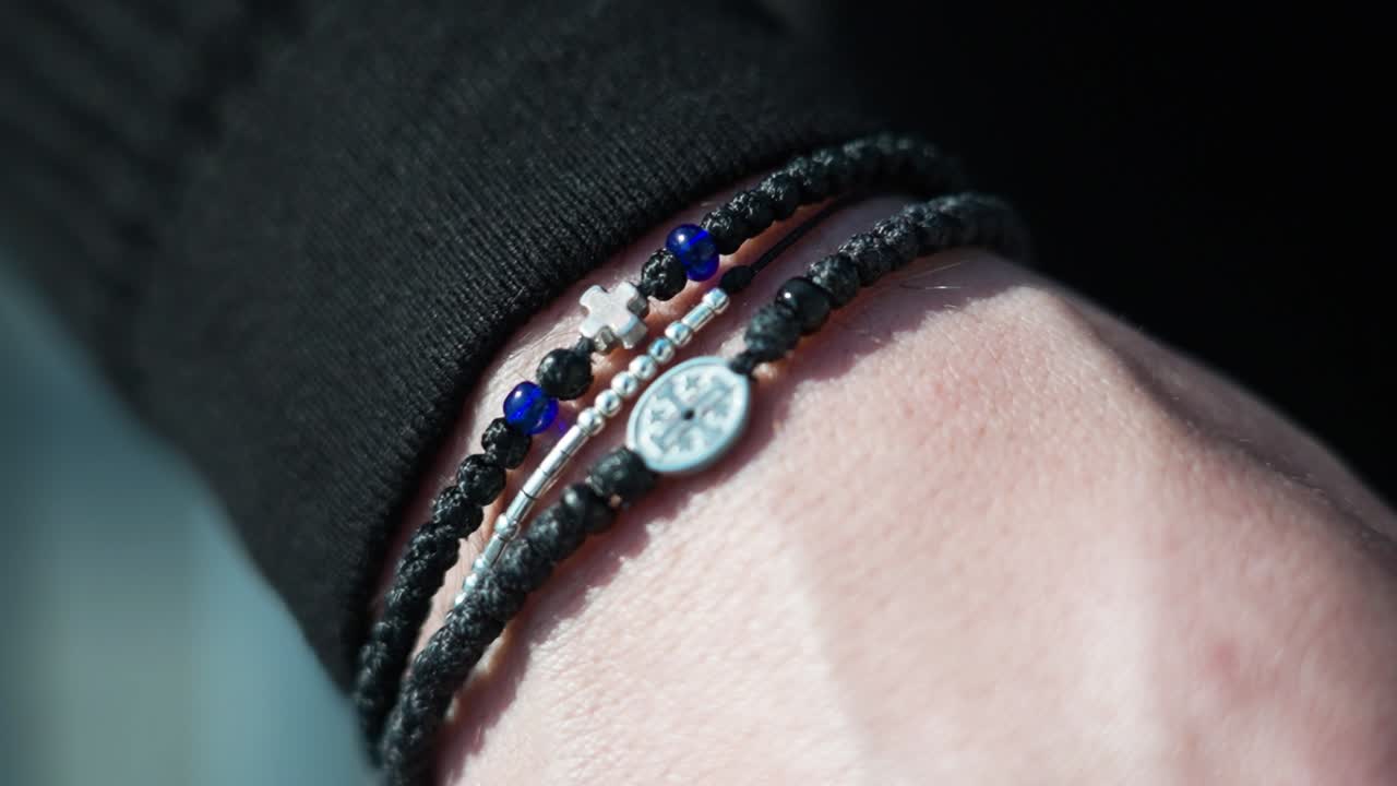 Close-up of a hand wearing bracelets outdoors