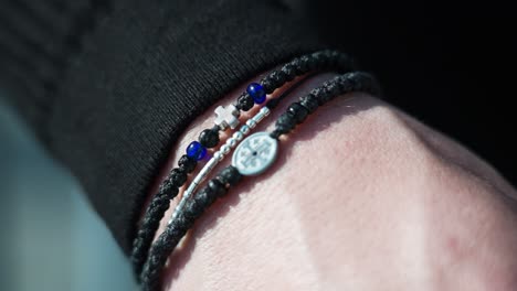 close-up of a hand wearing bracelets outdoors