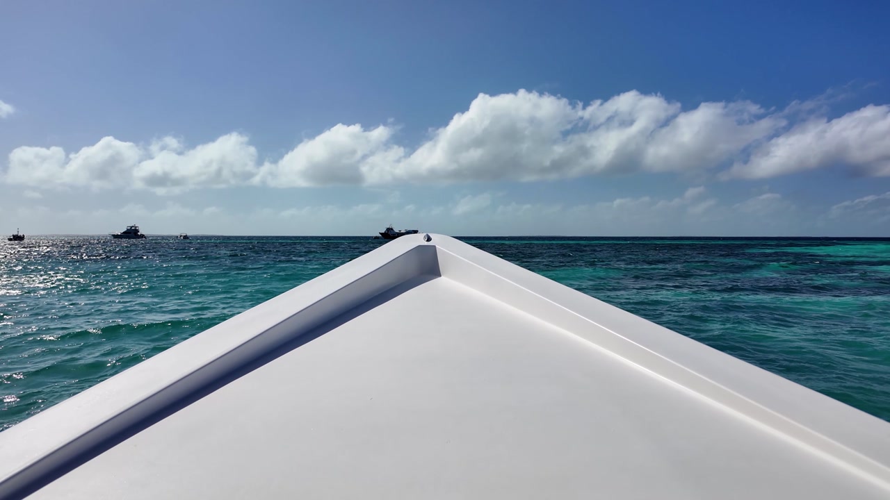Sailing on Caribbean sea from boat's viewpoint under cloudy sky