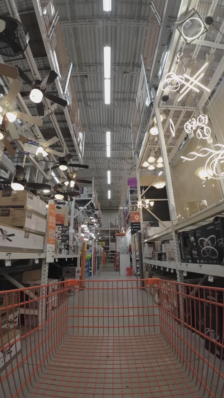 Interior view of a warehouse store with shelves and a shopping cart