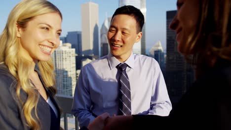 meeting of multi ethnic business executives on rooftop