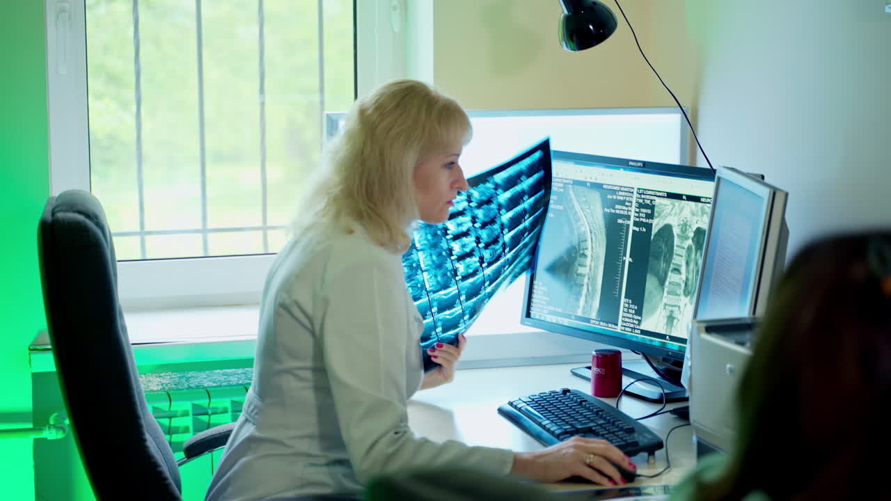 Doctor examining x-ray images. Portrait of female doctor looking at x-ray
