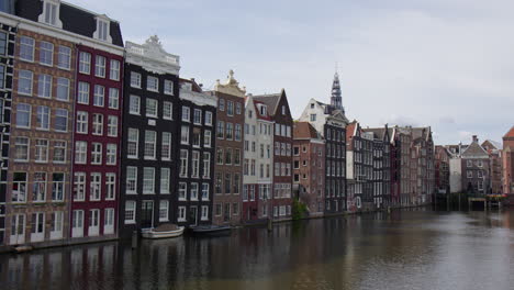 colorful buildings lining the canals at amsterdam capital city in the netherlands. static shot