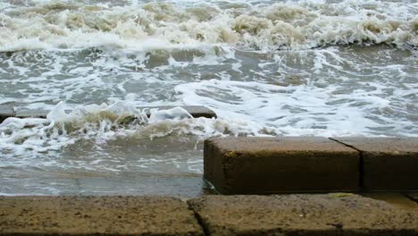 waves in the ocean breaking against cliffs