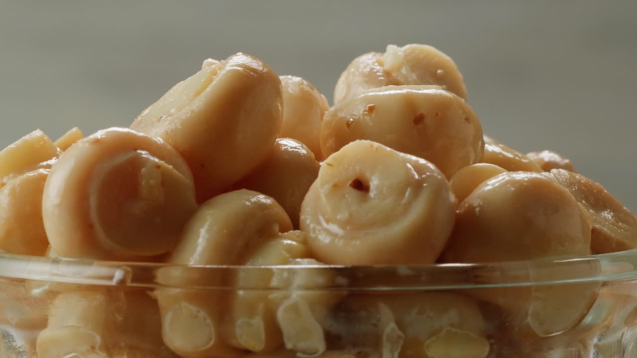 Fermented champignons, Jar with marinated mushrooms on wooden table, traditional salted marinated asian food.