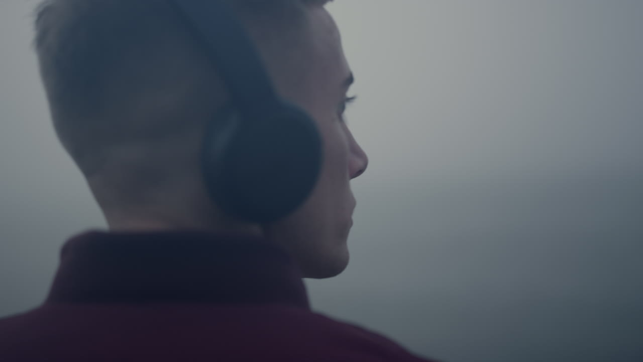 음악을 듣는 사려 깊은 남자 헤드폰 클로즈업. 음악 리 ⁇ 에 머리를 움직이는 남자