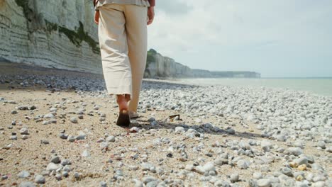 person walking on a rocky beach