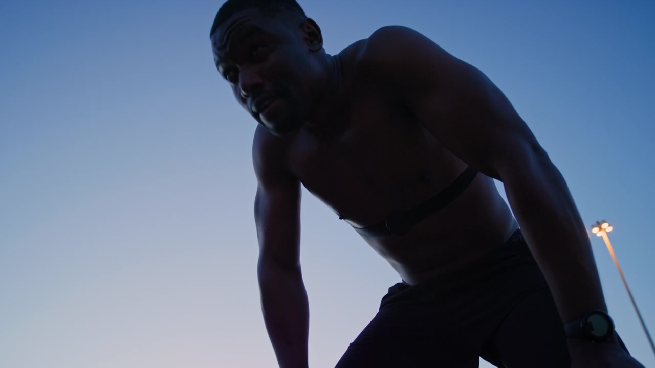 Exhausted Athlete Resting After Workout at Dusk