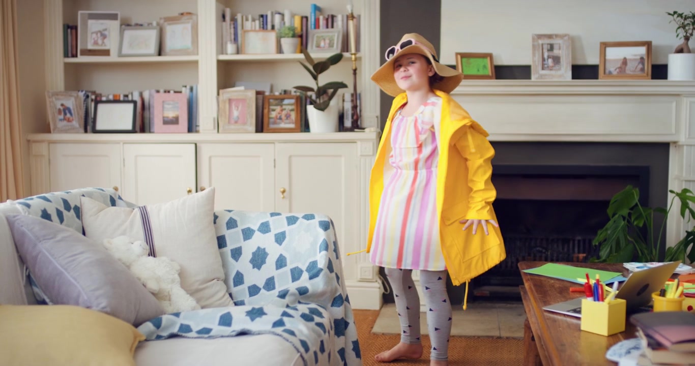 Young Girl Playing Dress Up in Yellow Raincoat and Hat