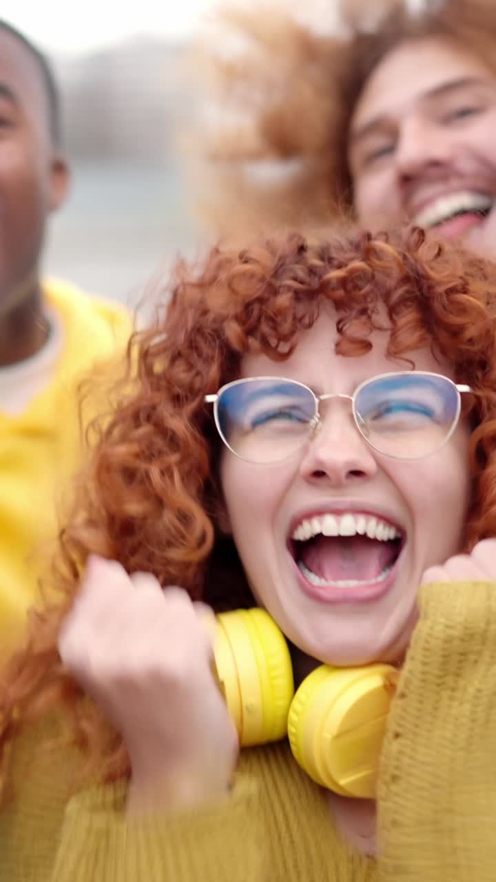 Multi-ethnic excited friends celebrating some success in the street