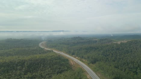 beautiful drone view of bau to lundu pan borneo highway during morning sunset with mountain and valley, green forest,sarawak, borneo.