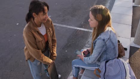 overhead view of a caucasian and a mixed race girl talking